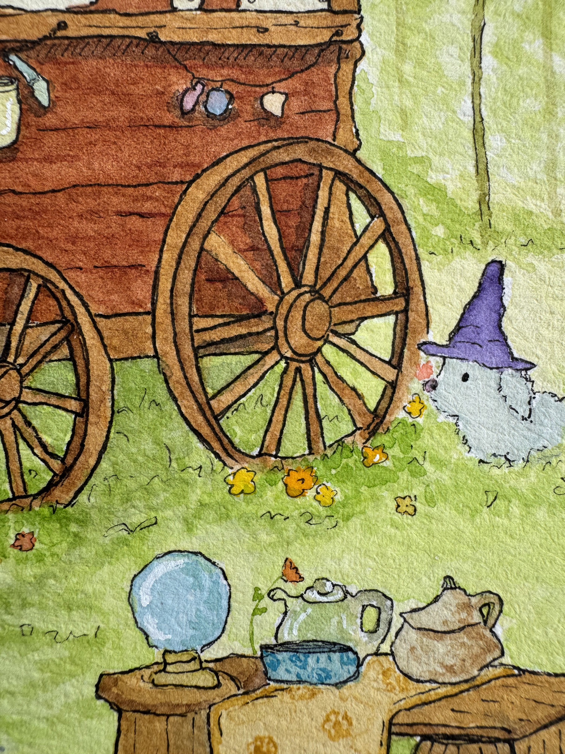 Watercolour close-up of a wooden travelling caravan wheel beside a tiny white bunny wizard wearing a purple pointed hat, surrounded by grass and yellow wildflowers.